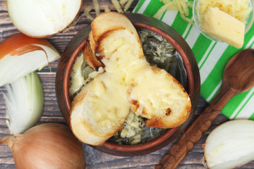 A ceramic pot with French onion soup
