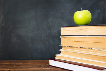 Green apple over pile of books for shool concept. Education concept, toned and soft focus image