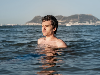 Young man relaxing and refreshing in the ocean