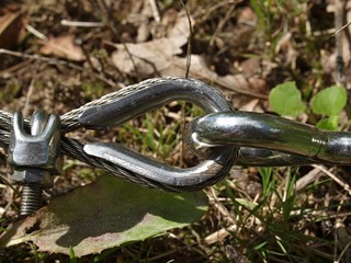 Closeup of a hook and and eye at a fence outside