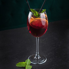 Cold sangria in a wine glass with mint