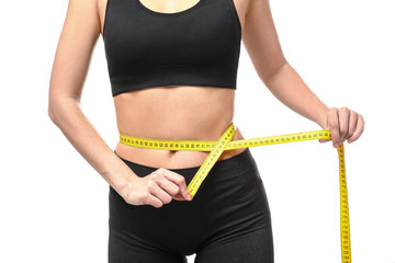 Young woman with measuring tape on white background. Weight loss concept