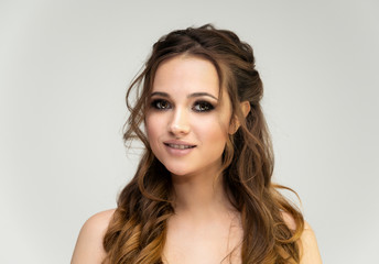 Fototapeta premium Beauty portrait of a beautiful girl with excellent makeup and good face skin and a wonderful hairstyle
