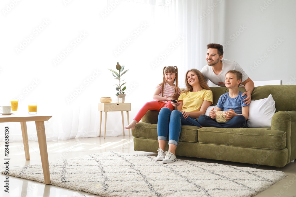 Wall mural happy family watching tv at home - Wall murals