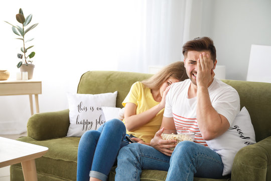 Couple Watching Scary Movie At Home