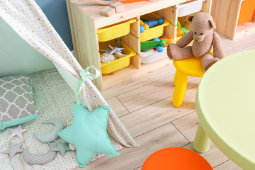 Interior of modern children's room with teepee