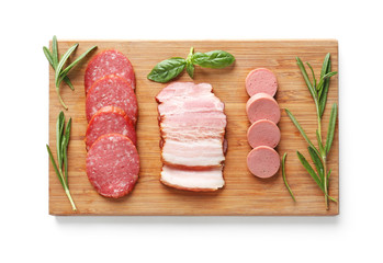 Wooden board with assortment of sausages on white background