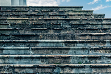 An antique stone staircase goes upstairs.