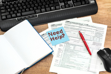 Business concept - tax 1040, with 'need help' text, notepad, keyboard