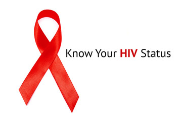 KNOW YOUR HIV STATUS inscription on white Background and red Ribbon as symbol of HIV and AIDS	