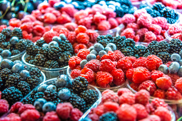Raspberries, blueberries and blackbarries on the street market