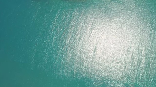 Aerial view Matukad island with sand beach and turquoise water in blue lagoon among coral reefs, Caramoan Islands, Philippines. Landscape with sea, tropical beach.