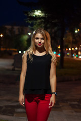 Art portrait of a beautiful girl. gorgeous blonde girl, portrait in night city lights.