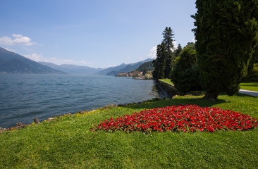 View of Bellagio on the background,  a small village on Como lake through the Villa Melzi Gardens, Italy.