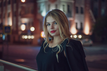 Art portrait of a beautiful girl. gorgeous blonde girl, portrait in night city lights.