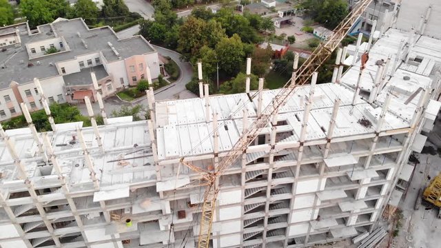 View from the drone of a multi-apartment high-rise building during construction.