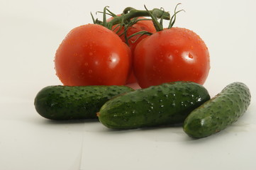 Fresh tomatoes and cucumbers isolated