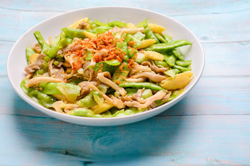 Stir Fry Snow Peas with corn and mushroom on white plated.