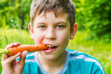 teen boy with carrot close up