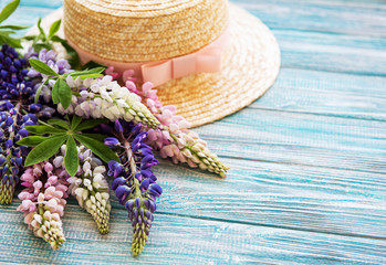 Straw hat and lupine flowers
