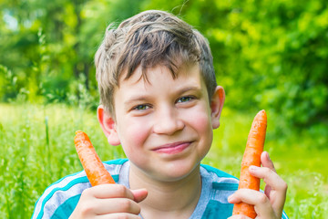teen boy with carrot close up