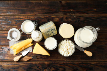 Fototapeta na wymiar Flat lay. Different dairy products on wooden background, copy space