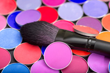 Female set of eye shadow and makeup brush close-up.