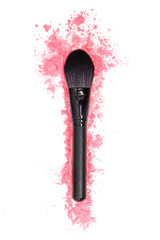 Black makeup brush and pink powder on a white isolated background.  Close-up.  View from above.