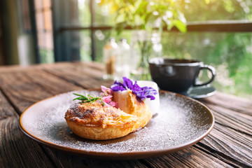 A piece of coconut pie with a beautiful decoration in a plate