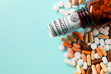USD dollar bills in a drug bottle over the medical pills. Medicine, healthcare industry and drug...