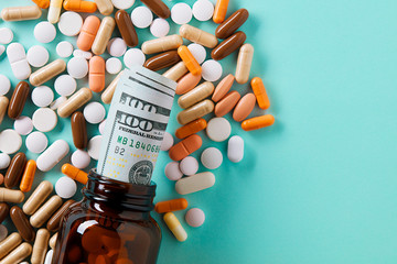 USD dollar bills in a drug bottle over the medical pills. Medicine, healthcare industry and drug...