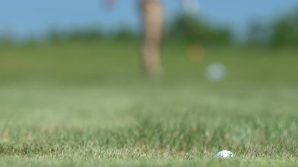 Male golfer making shot and missing hole, feeling angry and nervous, loser