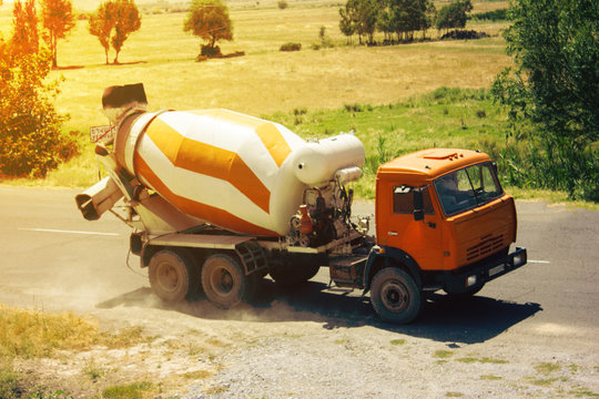 Construction industry - yellow concrete mixer in open countryside,