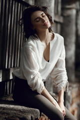 Fototapeta premium Autumn beauty portrait of a beautiful girl in the sunset. Lifestyle woman with natural makeup on nature. Romantic autumn mood