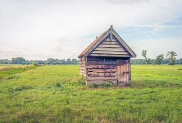 Skew wooden barn with orange roof tiles