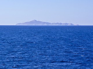 Island in Aegean sea covered with windmils for electricity production. Renewable energy sources  concept.