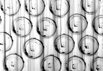 Abstract black and white Background with out of focus glass Rings on Bottles, texture