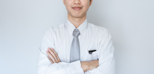 Business employee smiling in white shirt with arm crossed