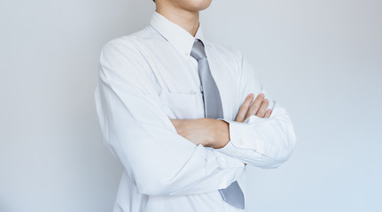 Business employee in white shirt with arm crossed