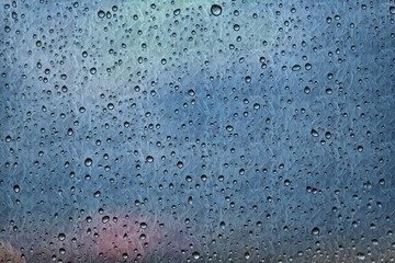 drops of rainwater on matte glass