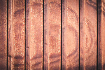 Rusty metal fence of corrugated flooring. Rear background.