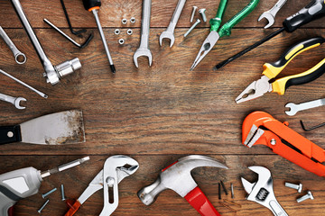 Assorted work tools on wooden background with copy space