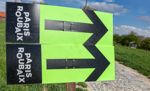 Templeuve,France- April 5, 2014: Route indicators, for Paris-Roubaix cycling race,are placed on the side of the cobblestone road near the Moulin de Vertain.