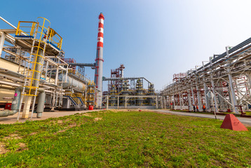 view of metal pipes of industrial plant outdoor at sunny day
