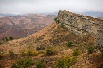 Picture of picturesque mountain area with green vegetation with smog on summer