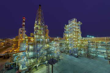 Fototapeta premium view of metal pipes of industrial plant outdoor at night 