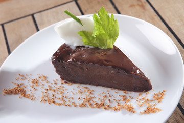 Chocolate dessert with peanut and walnut pieces.