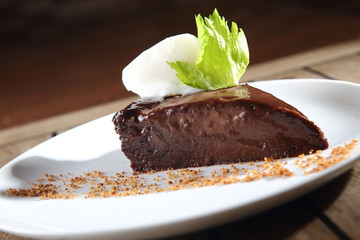 Chocolate dessert with peanut and walnut pieces.