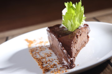 Chocolate dessert with peanut and walnut pieces.