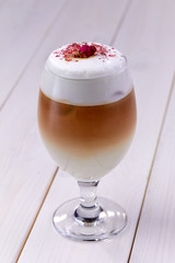 latte with rose on the wooden background